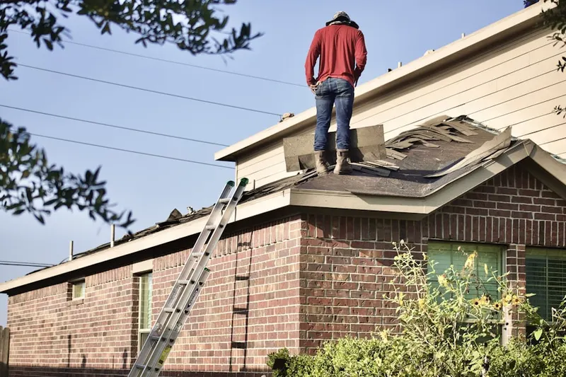 Professional roofer working on a residential roof in Long Lake